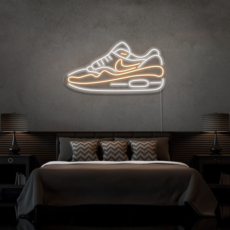 warm white air max 1 sneaker neon sign hanging on bedroom wall