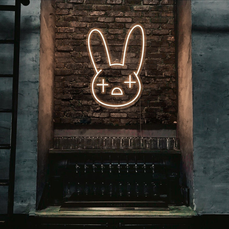 warm white bad bunny neon sign hanging on bar wall