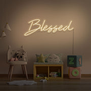 warm white blessed neon sign hanging on kids bedroom wall