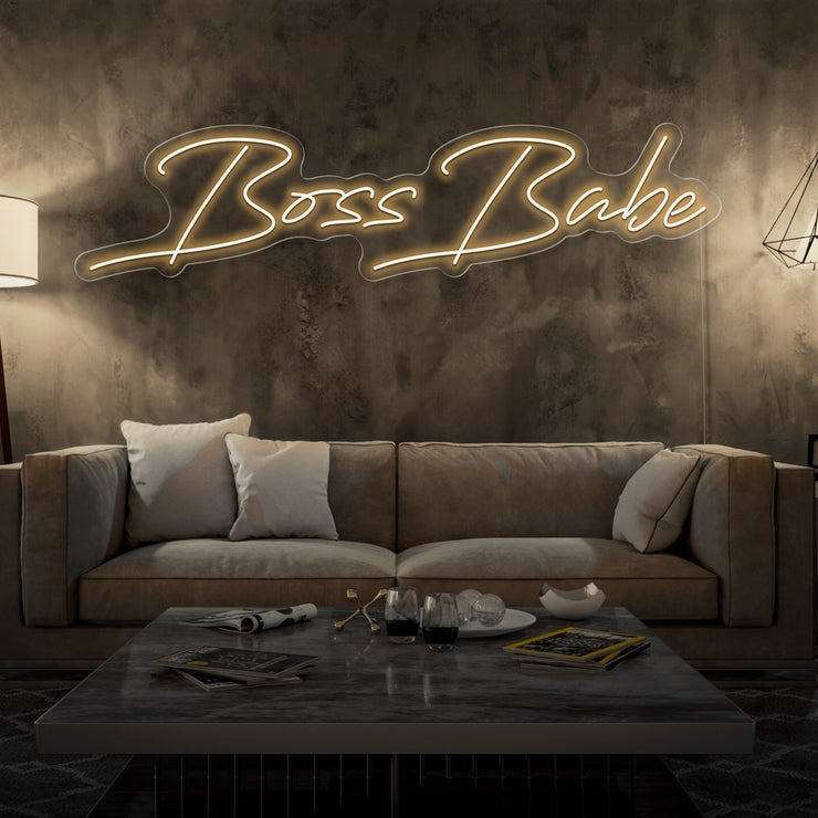warm white boss babe neon sign hanging on living room wall