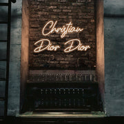 warm white christian dior dior neon sign hanging on bar wall