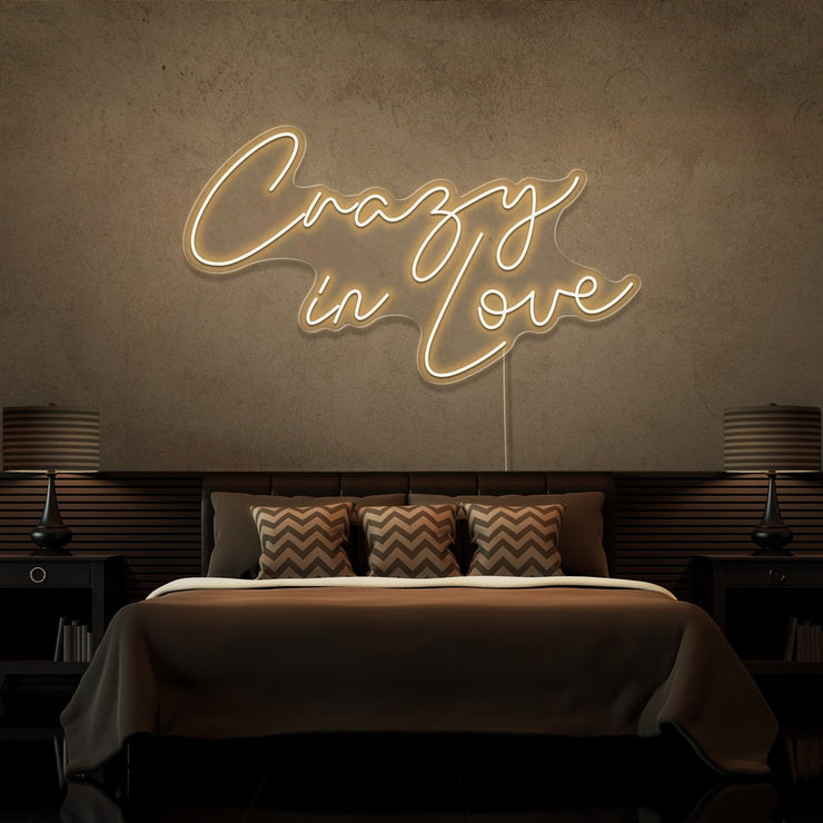 warm white crazy in love neon sign hanging on bedroom wall