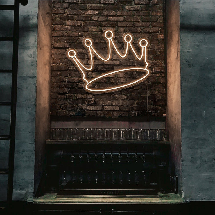 warm white crown neon sign hanging on bar wall