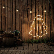 warm white draped ghost neon sign hanging on timber wall