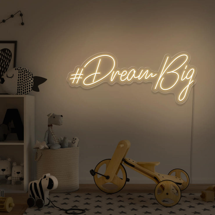 warm white dream big neon sign hanging on kids bedroom wall