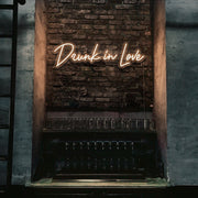 white drunk in love neon sign hanging on bar wall