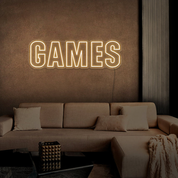 warm white games neon sign hanging on games room wall