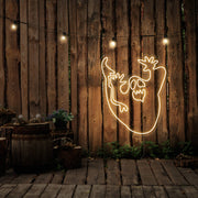 warm white ghost neon sign hanging on timber wall
