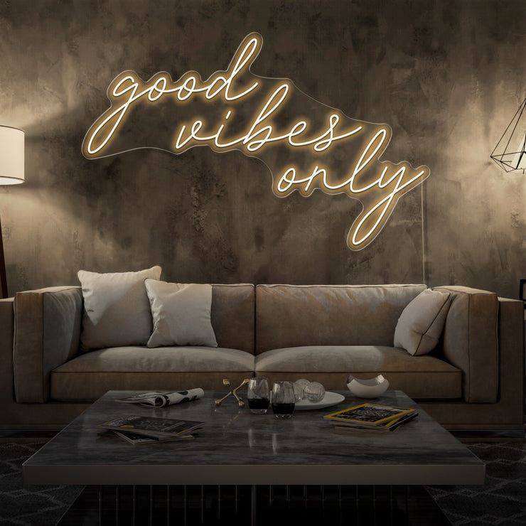 warm white good vibes only neon sign hanging on living room wall