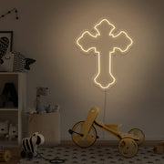 warm white cross neon sign hanging on kids bedroom wall