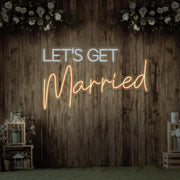 warm white lets get married neon sign hanging on timber wall