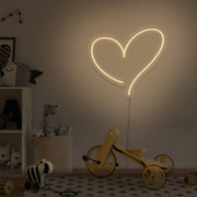 warm white love heart neon sign hanging on kids bedroom wall