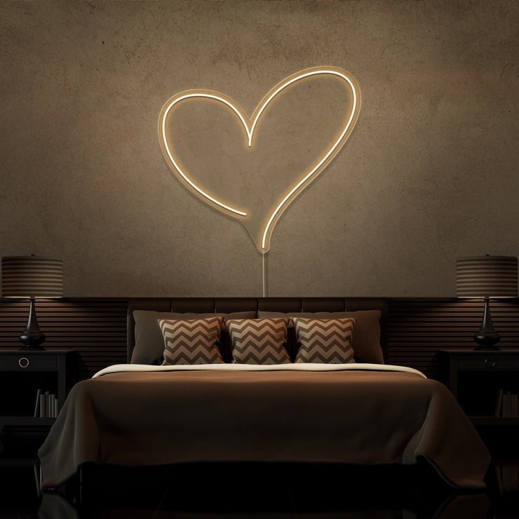 warm white love heart neon sign hanging on bedroom wall