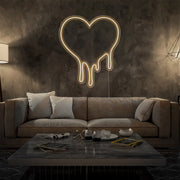 warm white melting heart neon sign hanging on living room wall
