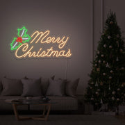 warm white merry chirstmas mistletoe neon sign hanging above couch next to christmas tree