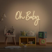 warm white oh baby neon sign hanging on kids bedroom wall