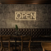 warm white open neon sign hanging on cafe wall