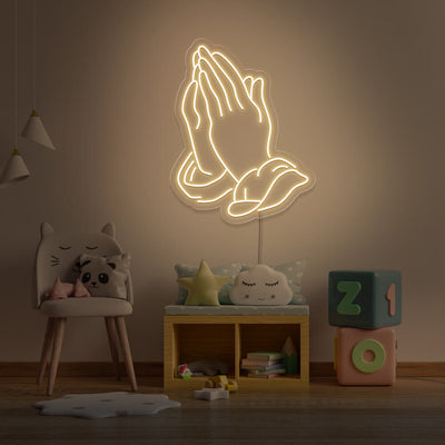warm white praying hands neon sign hanging on kids bedroom wall
