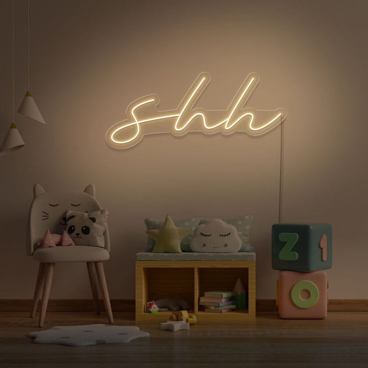 warm white shh neon sign hanging on kids bedroom wall