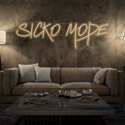 warm white sicko mode neon sign hanging on living room wall
