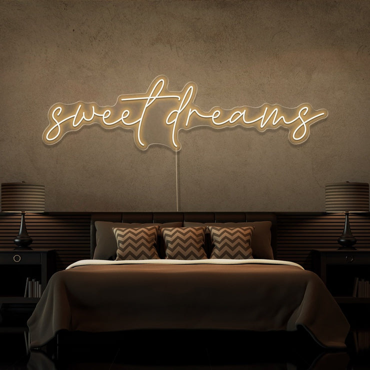 warm white sweet dreams neon sign hanging on bedroom wall