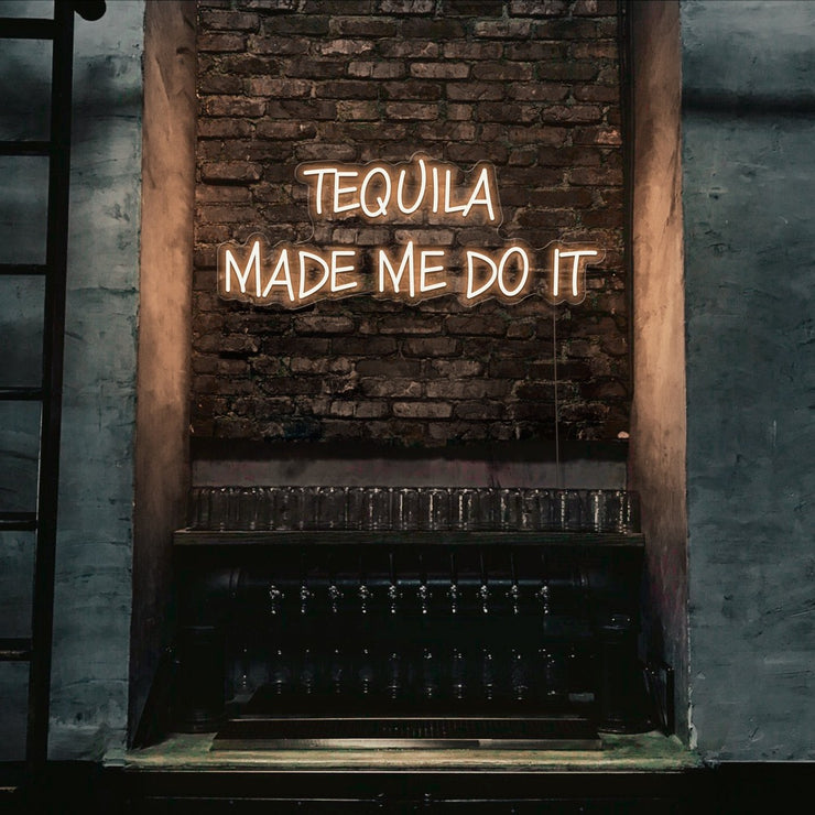 warm white tequila made me do it neon sign hanging on bar wall