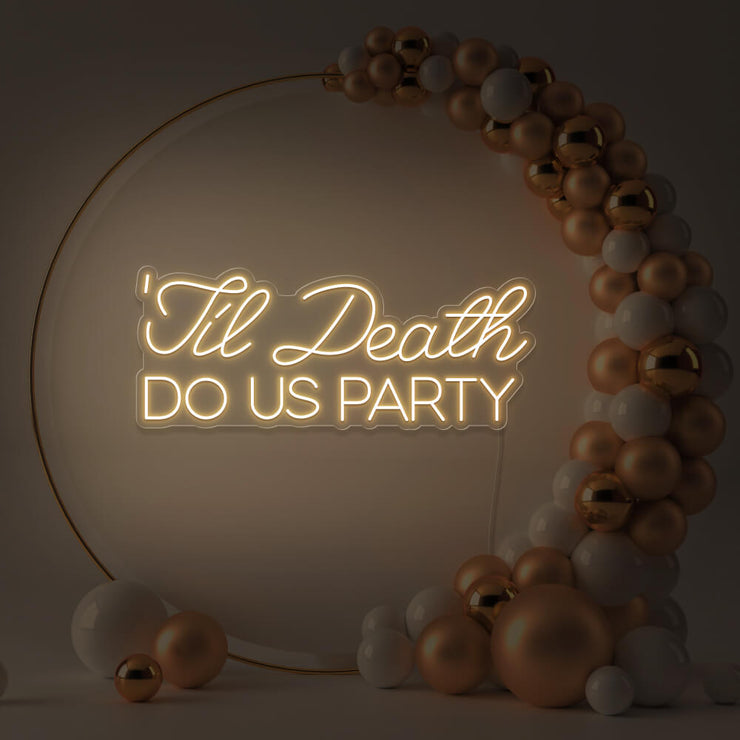 warm white til death do us party neon sign in gold hoop backdrop with balloons