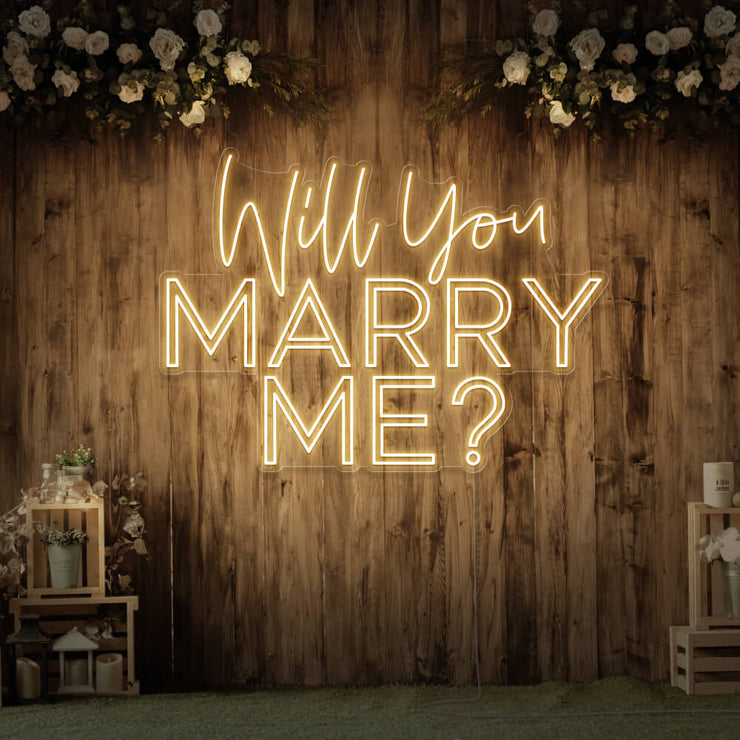 warm white will you marry me neon sign hanging on timber wall
