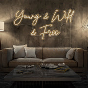 warm white young and wild and free neon sign hanging  on living room wall
