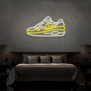 yellow air max 1 sneaker neon sign hanging on bedroom wall