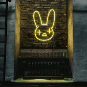 yellow bad bunny neon sign hanging on bar wall