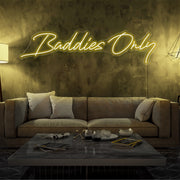yellow baddies only neon sign hanging on living  room wall