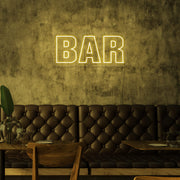 yellow bar neon sign hanging on bar wall