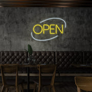 yellow open neon sign hanging on restaurant wall