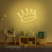 yellow crown neon sign hanging on kids bedroom wall