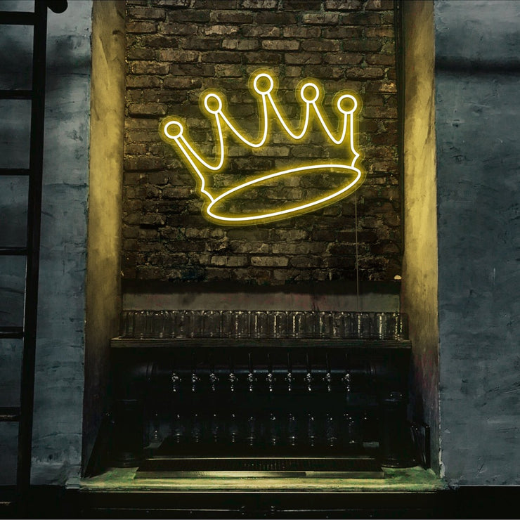 yellow crown neon sign hanging on bar wall