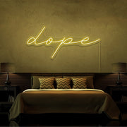 yellow dope cursive neon sign hanging on bedroom wall