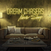 yellow dream chasers never sleep neon sign hanging on living room wall
