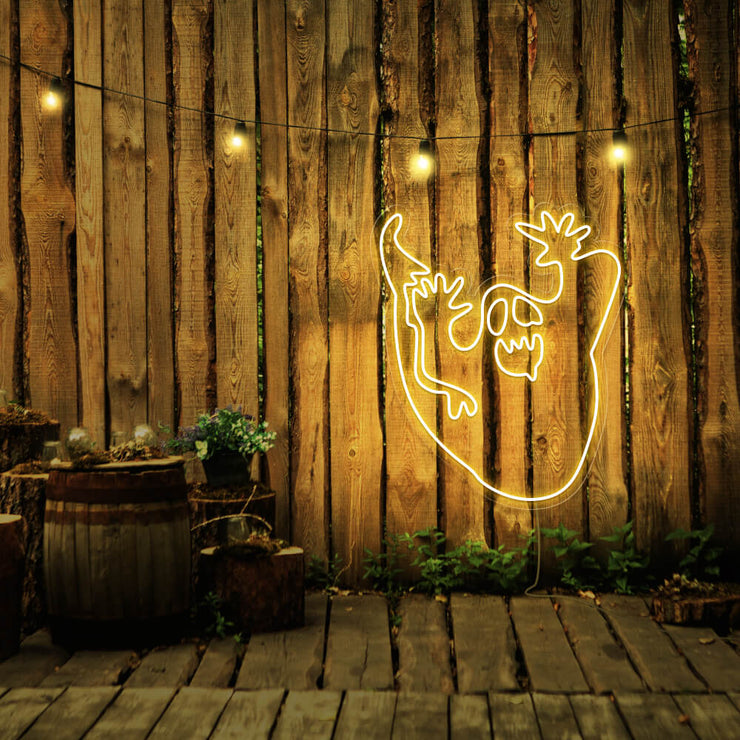 yellow ghost neon sign hanging on timber wall