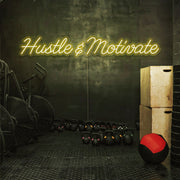 yellow hustle and motivate neon sign hanging on gym wall