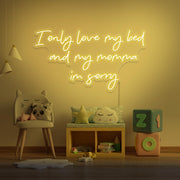 yellow I only love my bed and my momma I'm sorry neon sign hanging on kids wall
