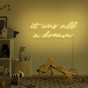 yellow it was all a dream neon sign hanging on kids bedroom wall