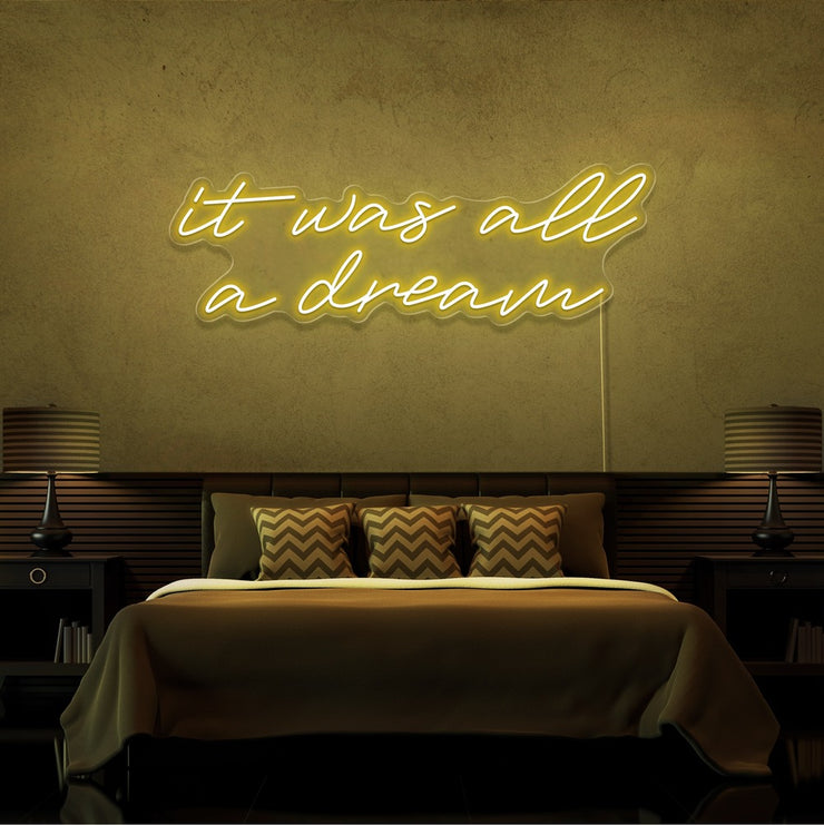 yellow it was all a dream neon sign hanging on bedroom wall
