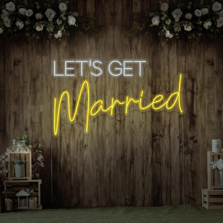 yellow lets get married neon sign hanging on timber wall