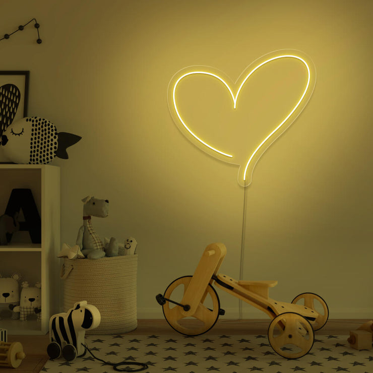 yellow love heart neon sign hanging on kids bedroom wall