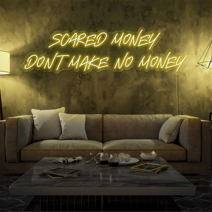 yellow scared money dont make no money neon sign hanging on living room wall