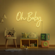 yellow oh baby neon sign hanging on kids bedroom wall