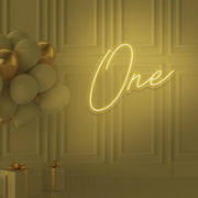 yellow 1st birthday neon sign hanging on wall with balloons