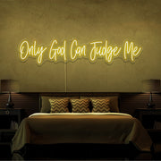 yellow only god can judge me neon sign hanging on bedroom wall