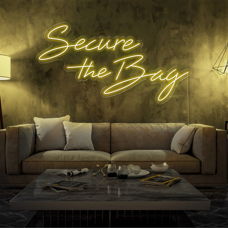 yellow secure the bag neon sign hanging on living room wall